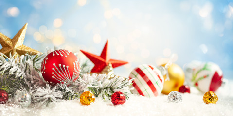Wall Mural - christmas winter background with gift box, christmas baubles and fir tree branches on snow.