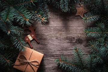 Wall Mural - A frame of fir branches and  gift paper box tied with twine. Christmas card blank.