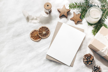 christmas blank greeting card mock-up scene. festive winter wedding composition. craft envelope, pin