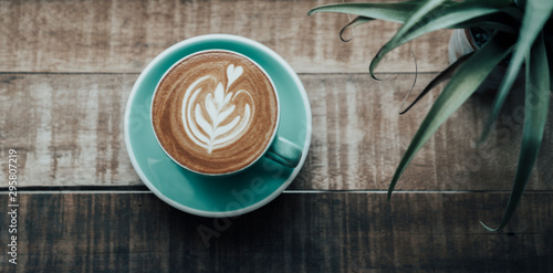 Top view latte art coffee on wooden table in cafe Poster Mural XXL