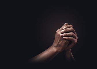 praying hands with faith in religion and belief in god on dark background. power of hope or love and