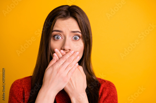 Close up photo of pretty girlish childish feminine girl having told restricted information unbelievable unexpected with mouth covered with hands isolated over yellow vivid color background