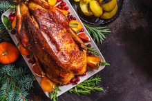 Christmas Baked Duck With Herbs And Fruits On Gray Plate, Dark Background.