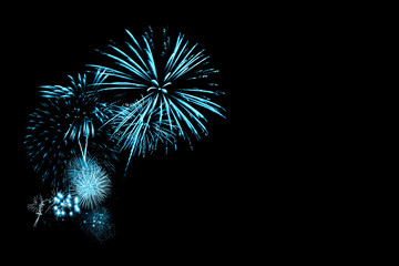 Wall Mural - blue fireworks in fireworks in black background