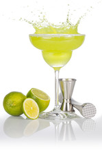 Bartender Tools And Lime Fruits Around A Splashing Margarita Glass