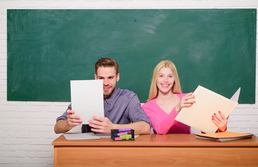 Couple friends students studying university. Guy and girl sit at desk in classroom. Correct answer on their mind. Enjoying university life. Studying in college or university. Apply for free program