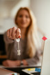 © JustLife - Young female agent holding a key