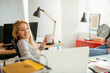 © JustLife - young businesswoman drinking coffee and using lap top in the office