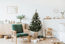 Modern Interior Design Living Room With Christmas / New Year Decorations, Toys, Gifts, Fir Tree. Winter Holidays Composition.