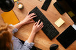 © JustLife - close up of females hand typing on keyboard