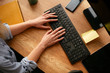 © JustLife - close up of females hand typing on keyboard