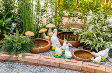 White Ducks Decoration Sculpture Setting On Flower Garden