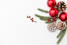 Winter Holidays, New Year And Decorations Concept - Red Christmas Balls And Fir Branches With Pine Cones On White Background