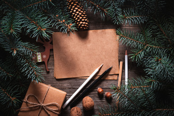 Wall Mural - A frame of fir branches and  gift paper box tied with twine. Christmas card blank.
