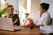 © JustLife - Two young women having coffee break in office