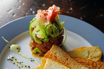 Wall Mural - Plate of raw tuna poke with fresh avocado and pickled ginger