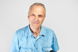 © amixstudio - Portrait of a Caucasian elderly man smiling on a white studio background. Handsome gray-haired old pensioner with a friendly kind face