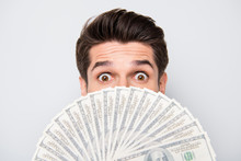 Close Up Cropped Photo Of Crazy Excited Man Hiding Behind Fan Of Money Staring Into Camera Not Willing To Share His Way Of Earning Money With You Isolated Over Grey Color Background