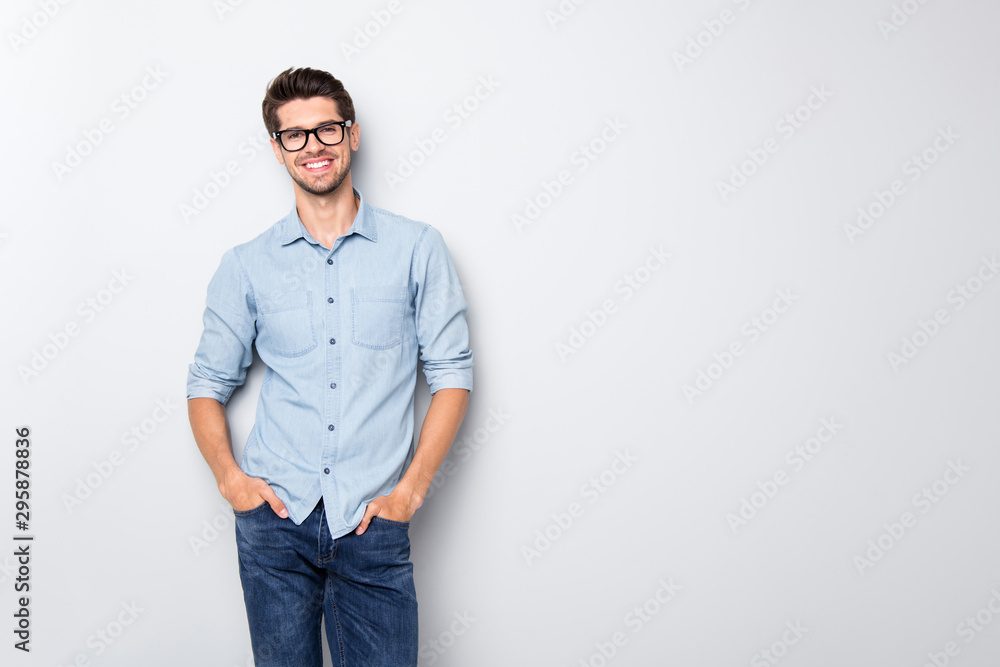 Photo of cheerful funky positive intelligent man smiling toothily holding hands in pockets isolated over grey color background - obrazy, fototapety, plakaty 