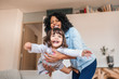 © mavoimages - Mother playfully swinging her little daughter in the air