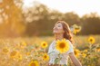 © Kristina89 - Young Asian woman with curly hair in a field of sunflowers at sunset. Portrait of a young beautiful asian woman in the sun.