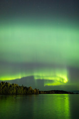 Wall Mural - northern lights over lake in finland
