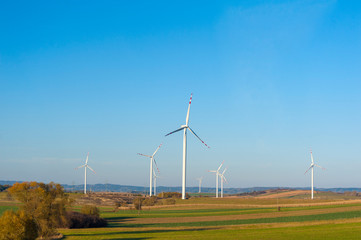  Wind turbines generating electricity. Electrical windmills.