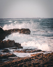 Waves Crashing On Rocks.