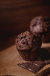 Chocolate muffins on a wooden chopping board from above, dark moody food photography