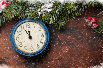 Christmas fir tree and alarm clock over old wood