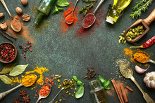Variety Of Natural Organic Spices On A Spoons On A Dark Green Slate, Stone Or Concrete Background. Top View With Copy Space.