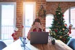 © Krakenimages.com - Beautiful woman sitting at the table working with laptop at home around christmas tree rubbing eyes for fatigue and headache, sleepy and tired expression. Vision problem