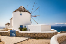 Mykonos, Greece. Scenic View Of Famous Whitewashed Windmills In Town At The Coast On A Beautiful Summer Vacation Day.
