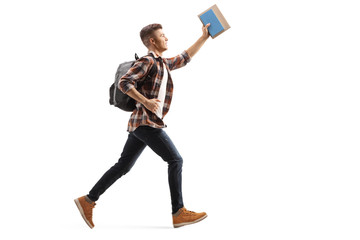 Wall Mural - Male student running and holding a book