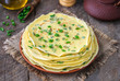 © Iryna - Asian cuisine. Stack of thin chinese egg and scallion pancakes. Dark wooden background, selective focus.