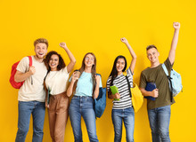Group Of Happy Students On Color Background