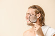 © Pixel-Shot - Portrait of young man with acne problem and magnifier on color background