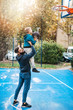 © hedgehog94 - Father and his son enjoying together on basketball court.