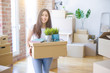 © Krakenimages.com - Young beautiful woman moving cardboard boxes at new home