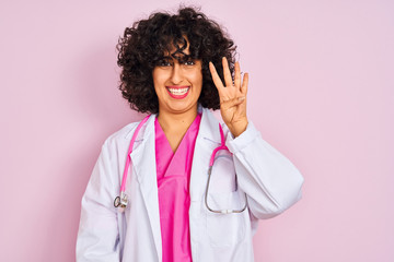 Sticker - Young arab doctor woman with curly hair wearing stethoscope over isolated pink background showing and pointing up with fingers number four while smiling confident and happy.