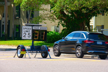 Radar Speed Limit Indicator Sign Monitored By The Police Showing 31 Miles Per Hour On The Screen Proving A Passing Car Is Speeding As It Drives Down The Road.