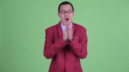 Wall Mural - Happy Asian businessman with eyeglasses clapping hands