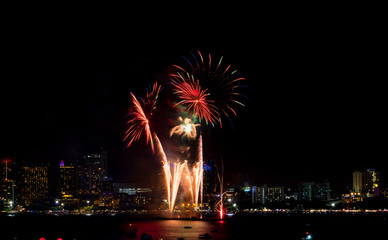 Wall Mural - Happy new year fireworks over cityscape at night.holiday celebration festival