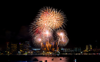 Wall Mural - Happy new year fireworks over cityscape at night.holiday celebration festival