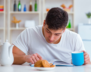 Wall Mural - Man falling asleep during his breakfast after overtime work