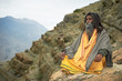 Indian monk sadhu at meditation in mountains