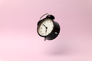 Vintage alarm clock on a pink clean background. Time management and time concept. Copy space