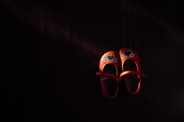 a pair of kid's shoes in the patch of light