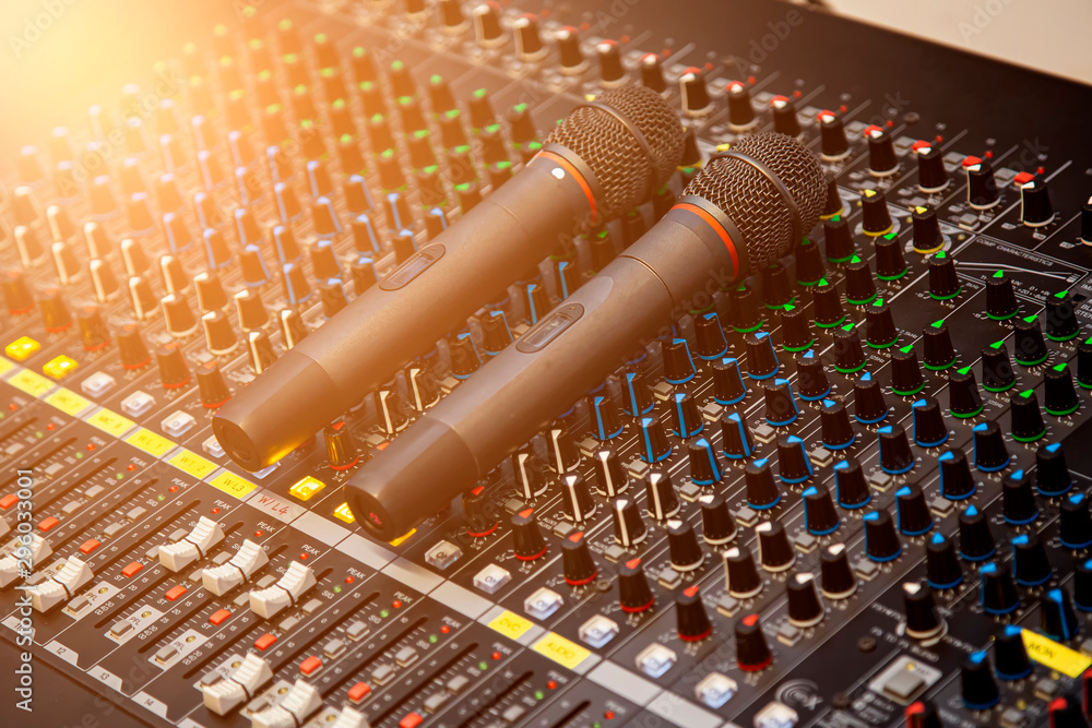 Microphone placed on the sound mixer with orange flare at the audio ...