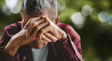 Wall Mural - senior man covering his face with his hands. Depression and anxiety Copy space.